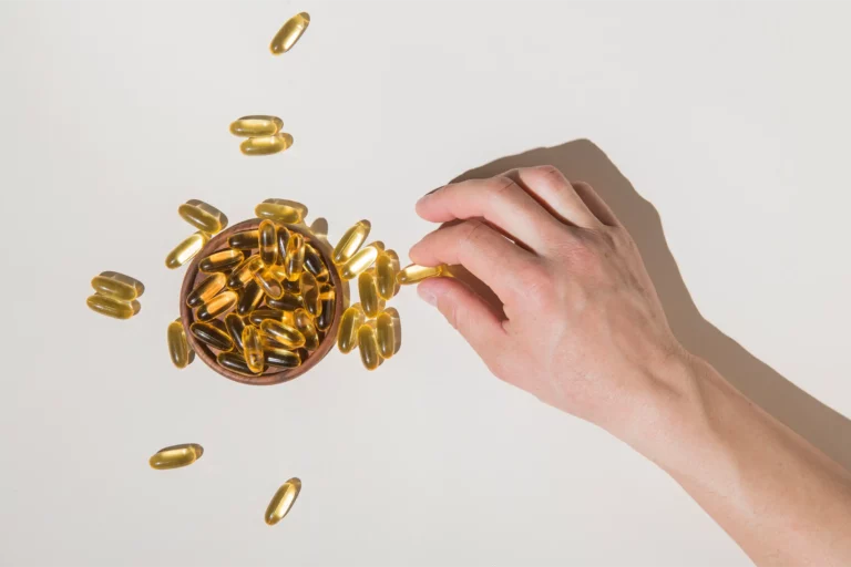 Main prenant des capsules d omega 3 illustrant le dosage journalier recommande en EPA DHA et ALA